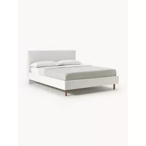 Cama tapizada con patas de madera Giulia